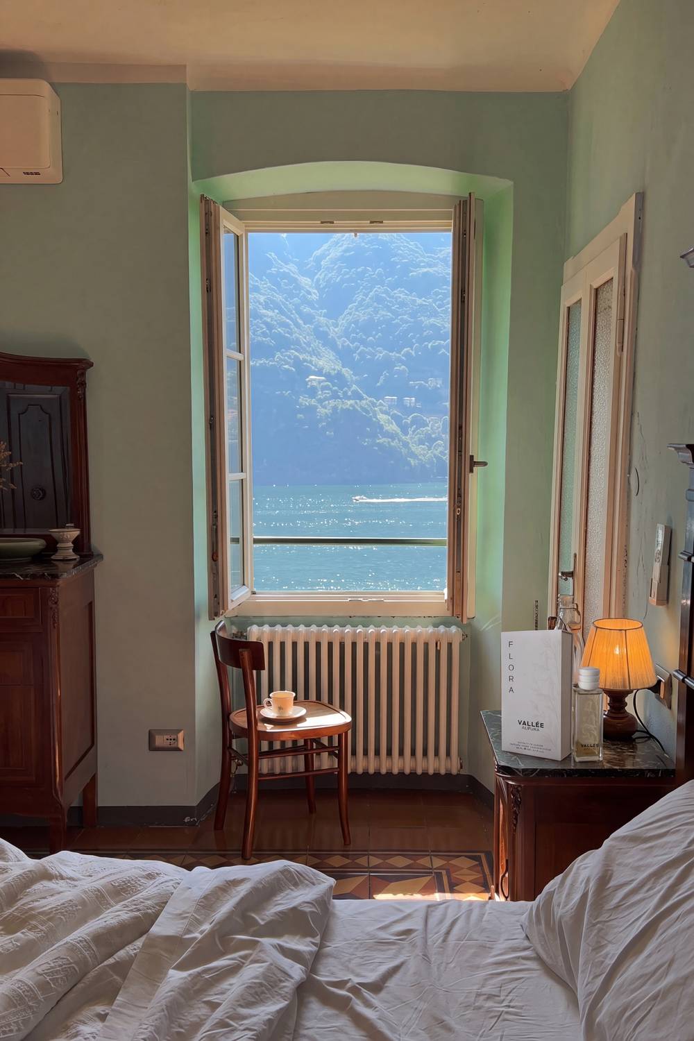 FLORA sul comodino di una camera d'albergo con vista sul lago